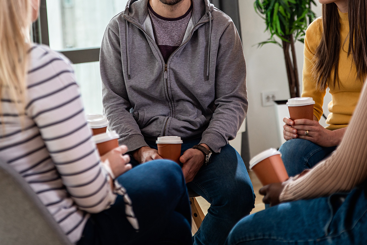 Group of people talking together in a group therapy session.