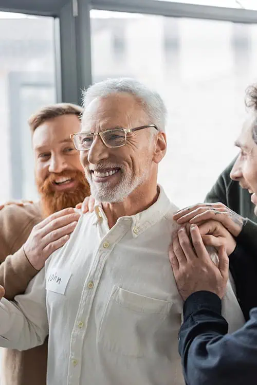 People participate in group therapy at a drug rehab.