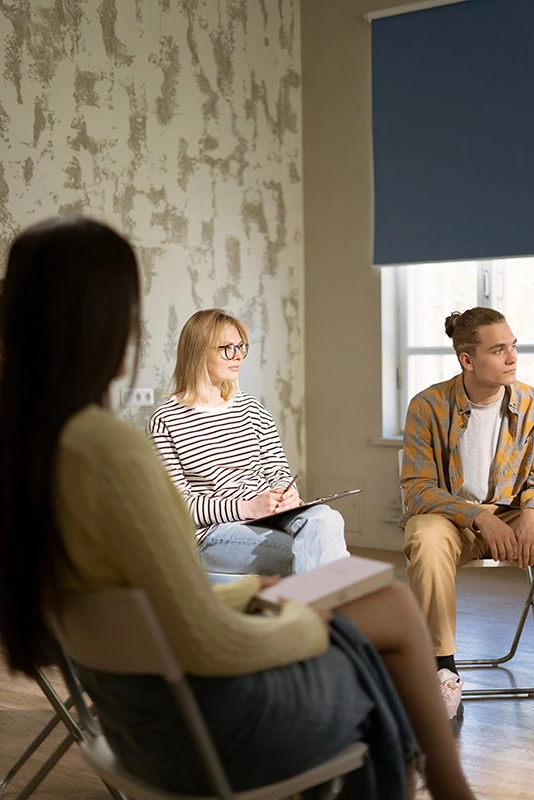 People participate in therapy at a drug rehab center.