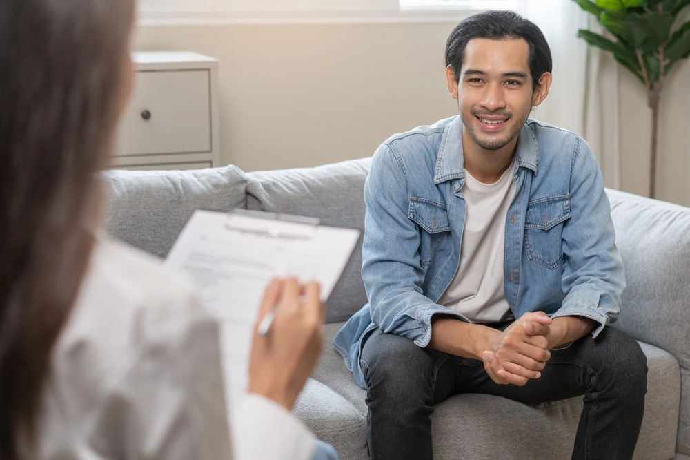 A man participates in therapy as part of a PHP in mental health.