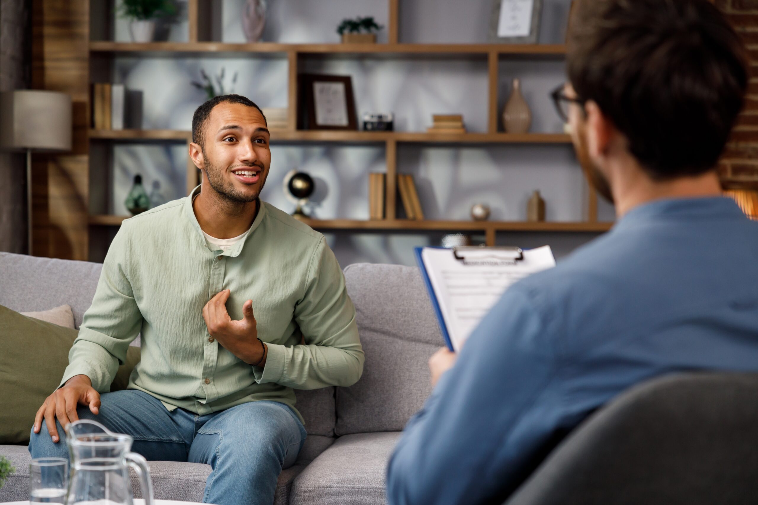 Man talking to his therapist about how to get into a sober living house.