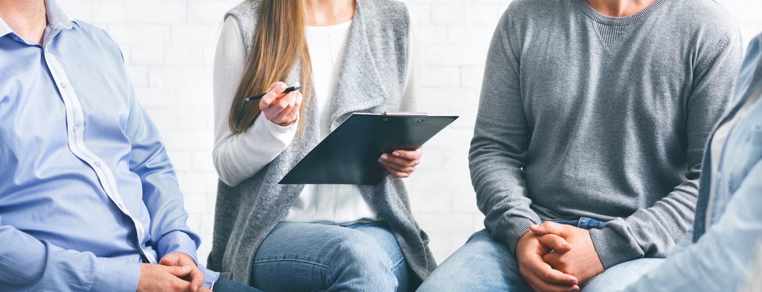 Therapist writing notes about Moral Reconation Therapy for addiction recovery.