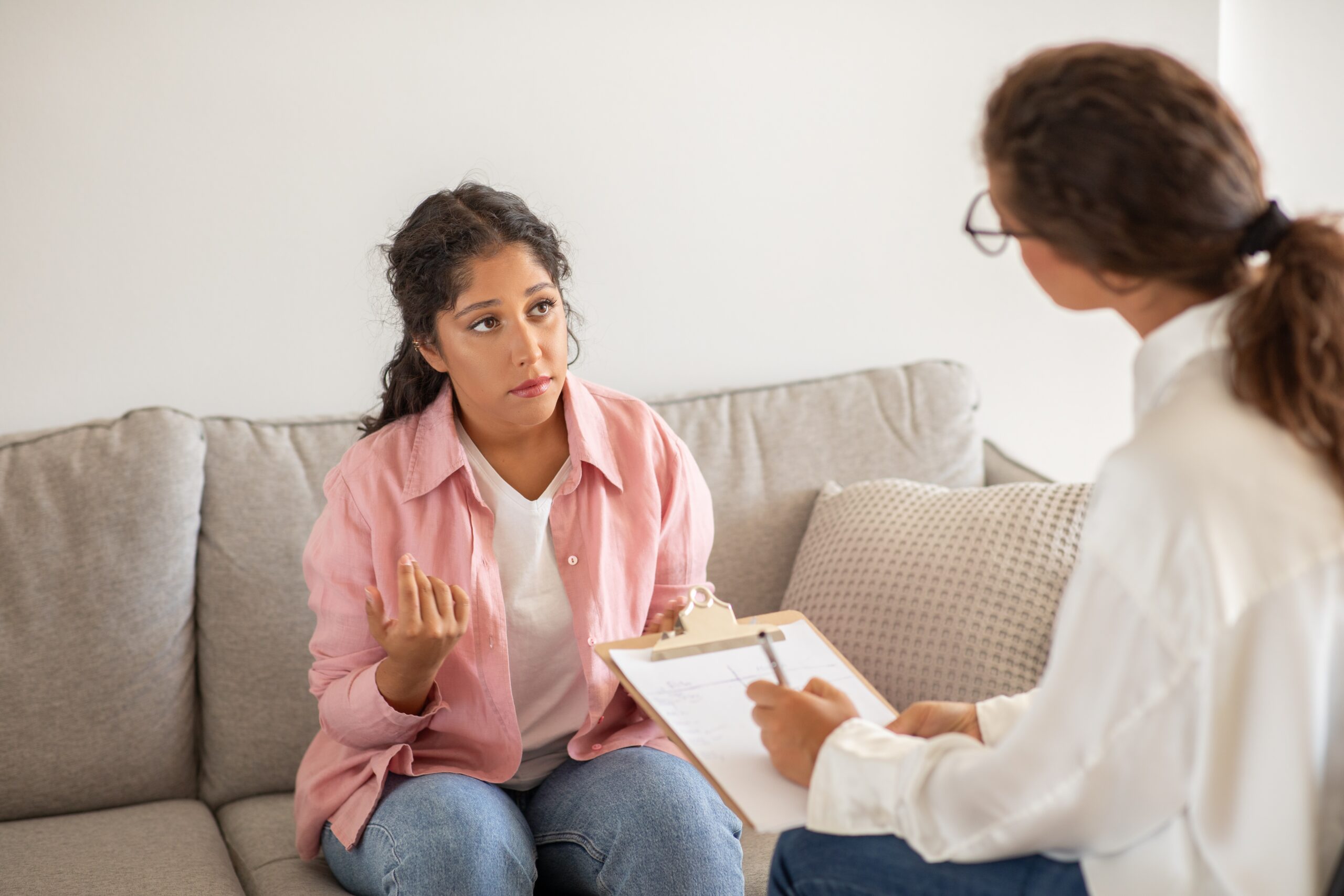 Woman talking to her therapist about drug rehab aftercare.