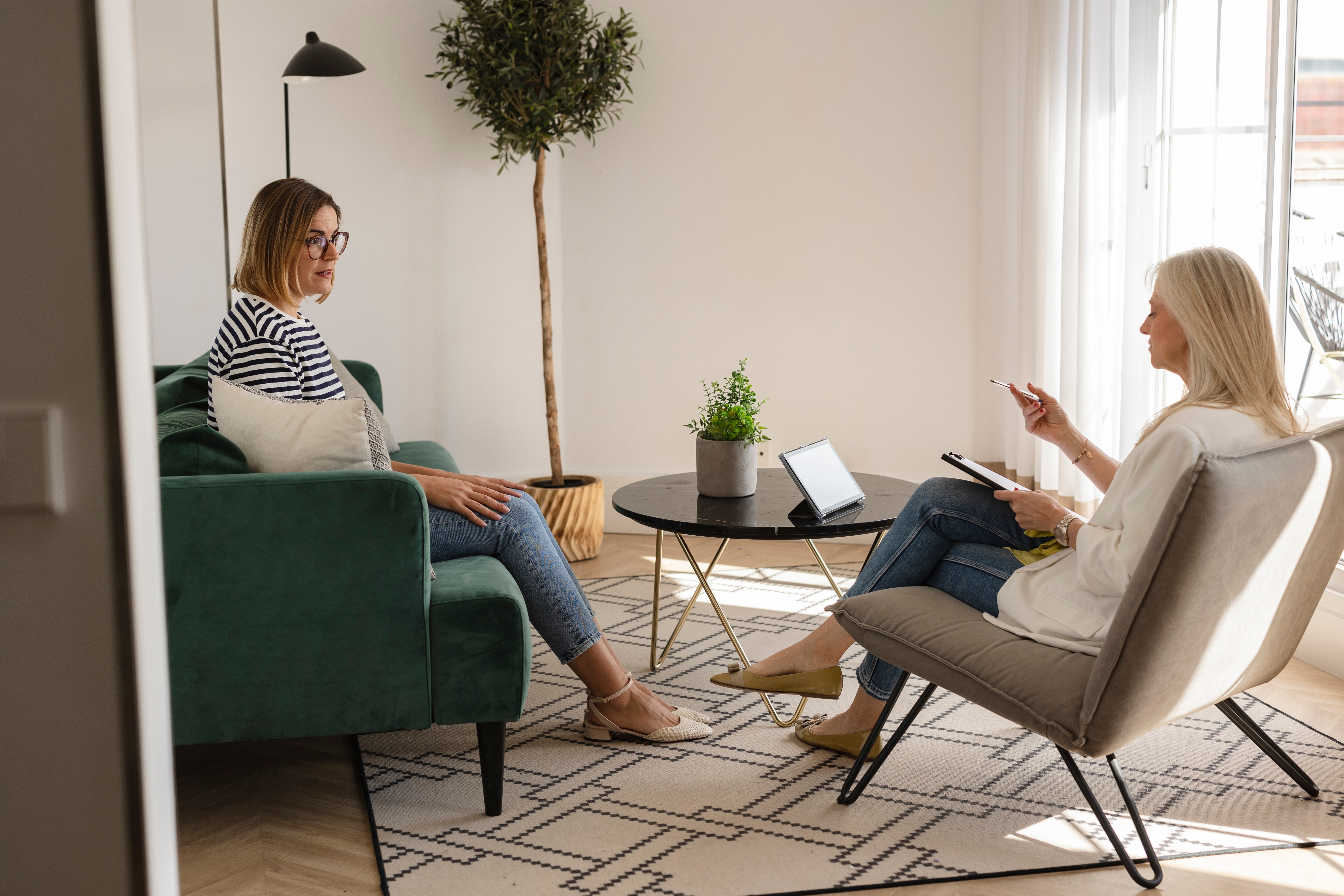 Woman talking to therapist about wellness & nutrition for addiction treatment.